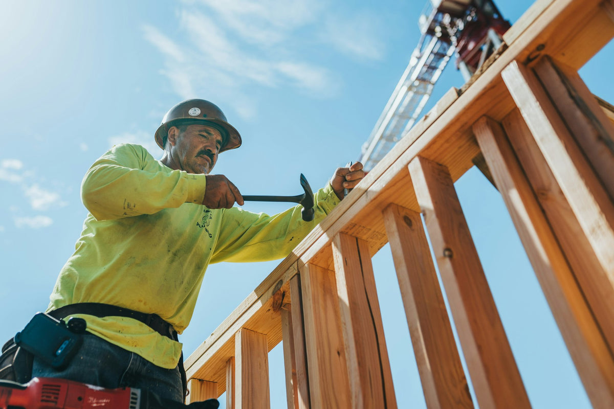 Framer building a wood frame on a construction site